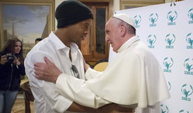 Pope Francis embraces Brazilian soccer star Ronaldinho during a meeting with the Scholas Occurrentes, an educational organization founded by the Pope, at the Vatican, Wednesday, Feb. 3, 2016. (L'Osservatore Romano/Pool photo via AP)