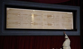 Pope Francis touches the case holding the Shroud of Turin after praying before the cloth in the Cathedral of St. John the Baptist in Turin, Italy, June 21. (CNS photo/Paul Haring) See POPE-TURIN June 22, 2015.